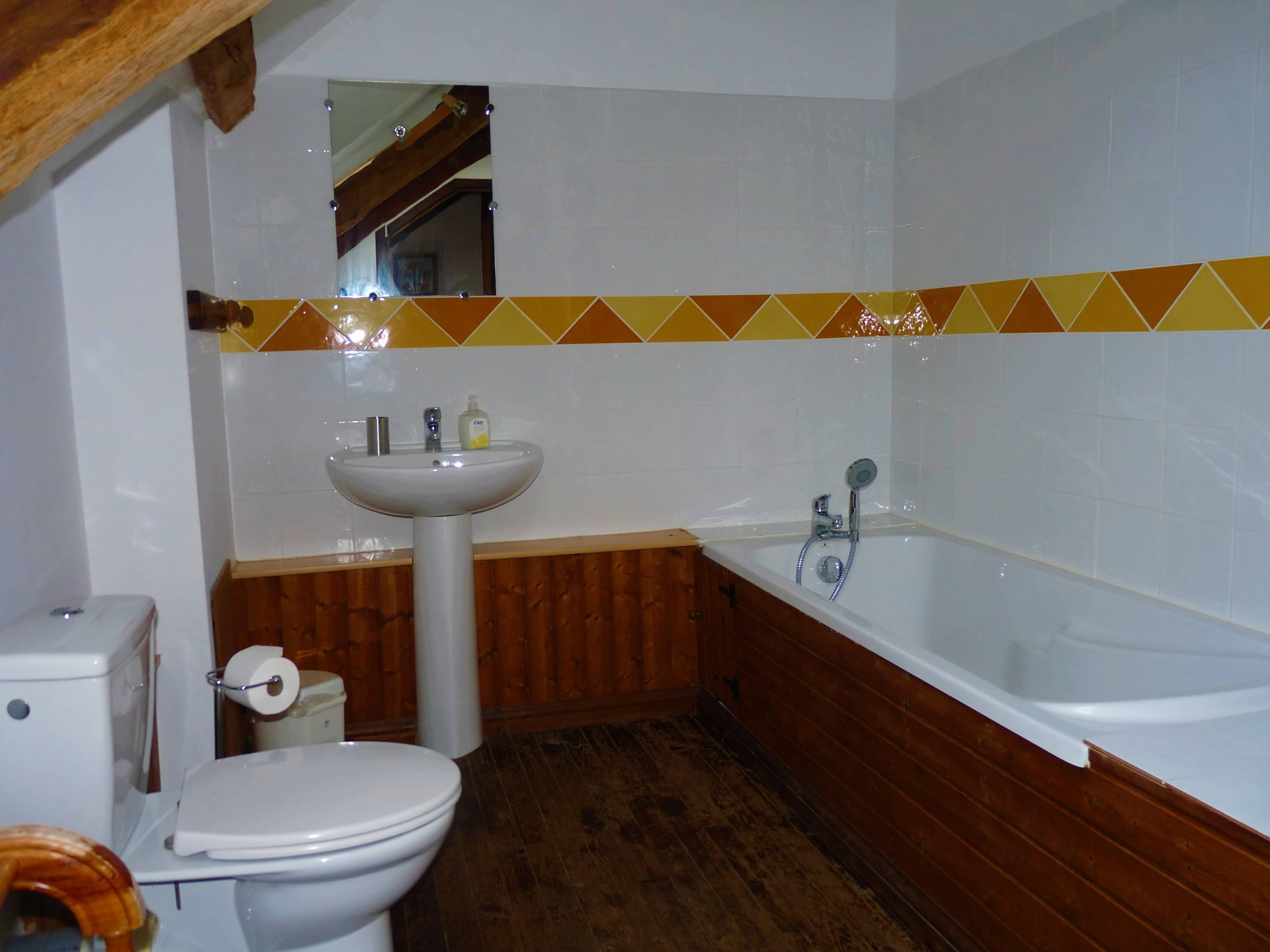 Modern and elegant bathroom of La Julerie cottage in Brittany, France, with a walk-in shower, mosaic tiles, and high-end amenities. Ideal for freshening up after a day of sightseeing in Brittany.